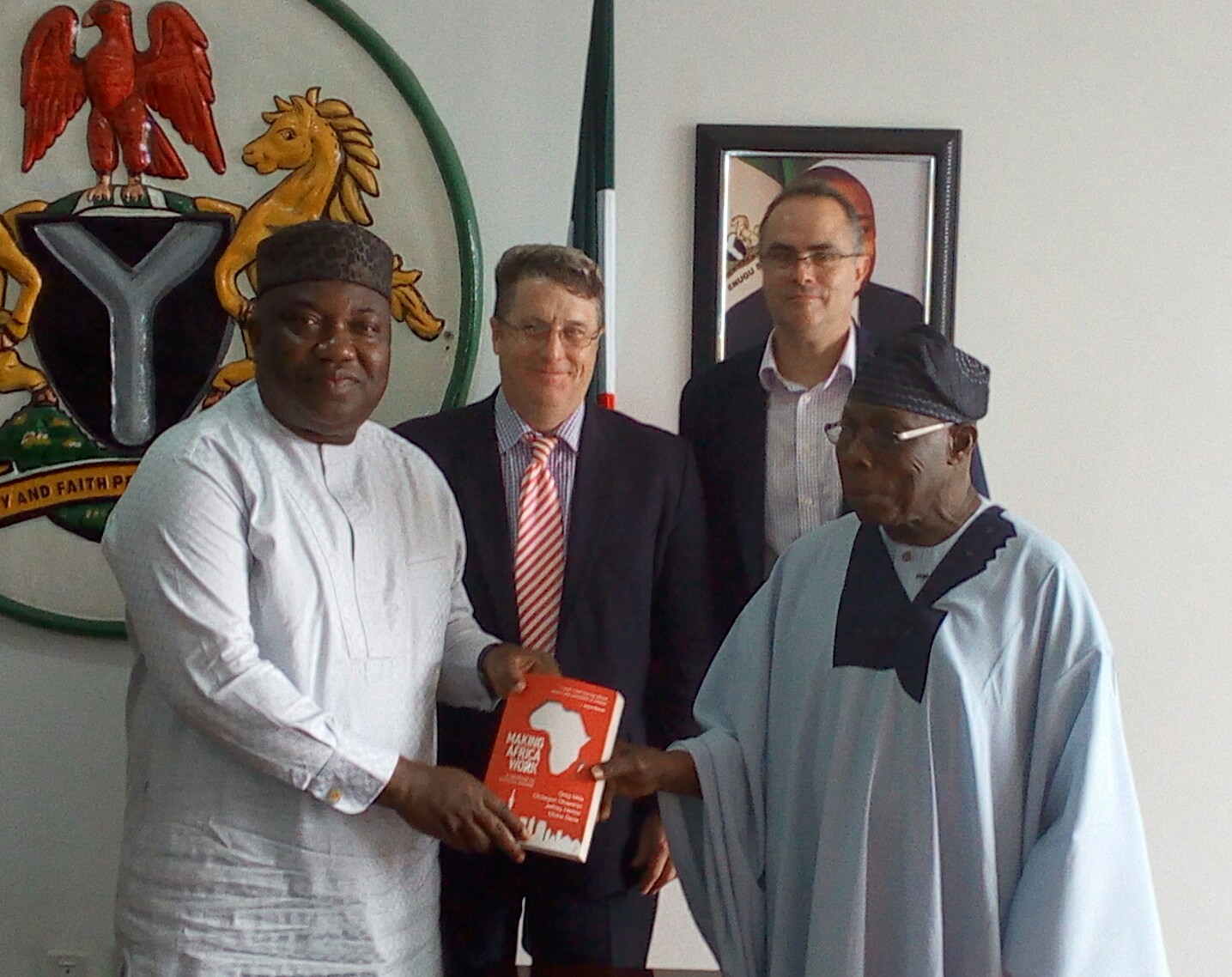 Gov. Ifeanyi Ugwuanyi of Enugu State (left), receiving a book from the former president of Nigeria and chairman of  The Brenthurst Foundation , Chief Olusegun Obasanjo (right);the CEO of the foundation, Dr. Greg Mills (2nd left); and  an associate of the foundation, Dickie Davis (2nd right); during a courtesy visit at the Government House, Enugu, yesterday.
