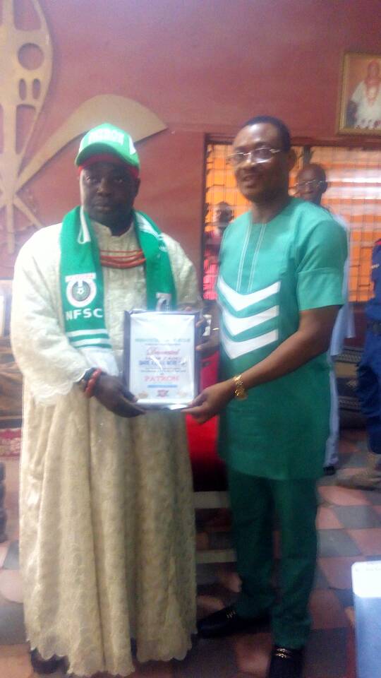 The Onojie of Ekpoma and the Chairman, Nigeria Football Supporters Club, Rev. Sam Ikpea at the palaceof the royal father during his investiture as patron of the club yesterday.