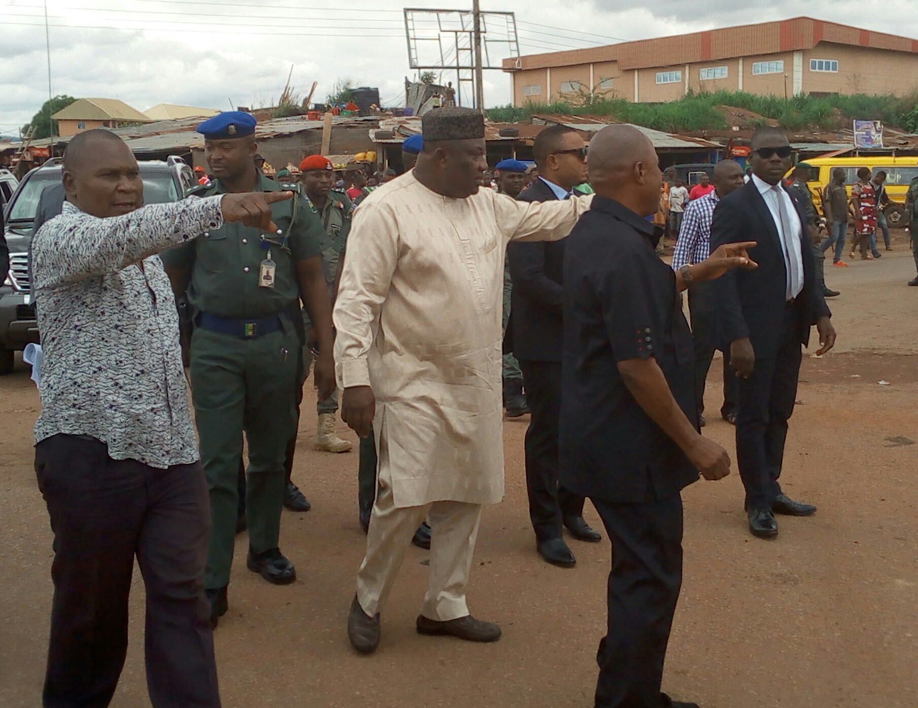 Gov. Ifeanyi Ugwuanyi of Enugu State (middle) with the Deputy Chairman of Nkanu West Local Government Area, Hon. Sunday Nnamani (left) and a stakeholder, Chief Mike Onu (right) during an inspection tour of the ongoing Urban Renewal projects on flood control and traffic de-congestion at Four-Corner junction, Ozalla, along Enugu -Port Harcourt expressway, yesterday.