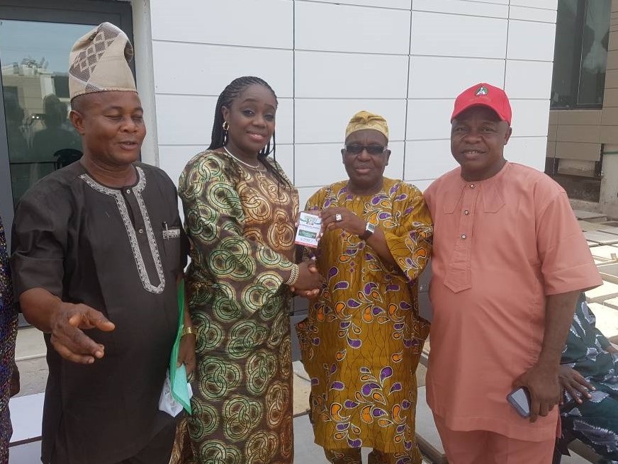 The National Financial Secretary of the All Progressives Congress (APC), Alhaji Tajudeen Bello (second right), handing over the membership card of the APC to the Honourable Minister of Finance, Mrs. Kemi Adeosun, in the presence of other party chieftains in Abeokuta, Ogun State, on Saturday, 5th May, 2018.