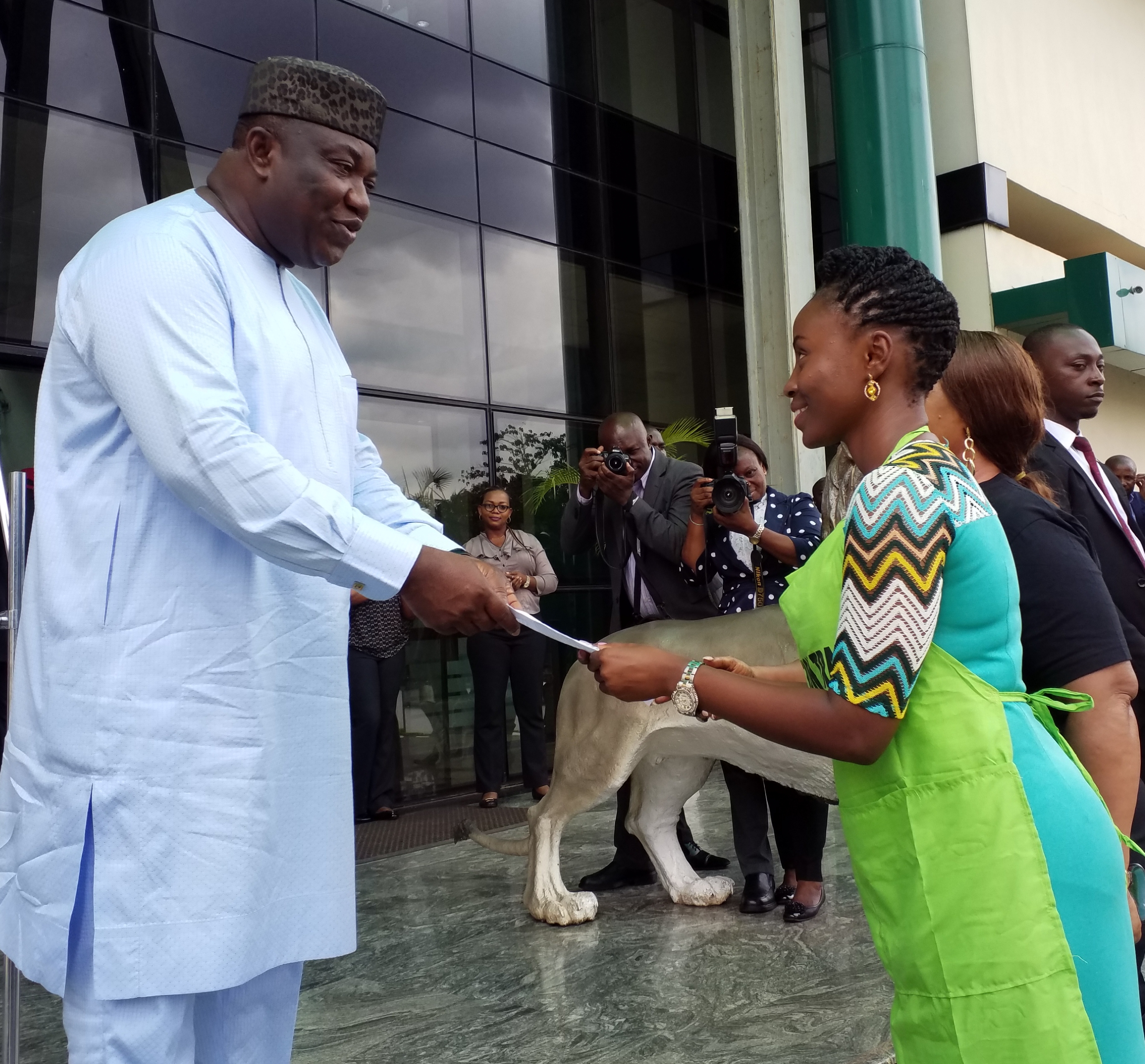 Governor Ifeanyi Ugwuanyi of Enugu State (left) receiving an appreciation letter from Miss Tochi Aboh, when the 750 beneficiaries of the state government’s Skill Acquisition programme paid him a thank-you visit at the Government House, Enugu.