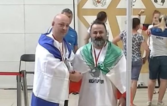 Iran bans weightlifter for life over handshake with Israeli